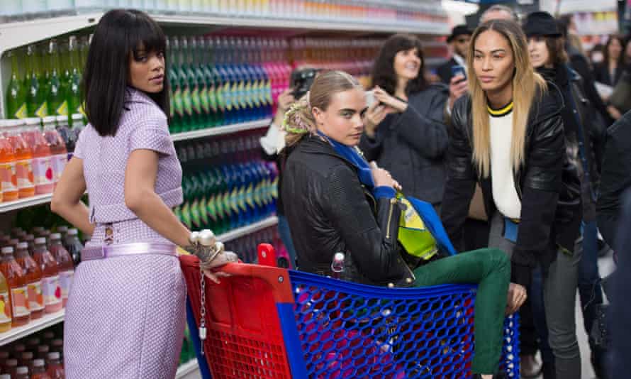 Trolleyed … Rihanna pushes model Cara Delevingne at the Chanel autumn-winter 2015 show in Paris.