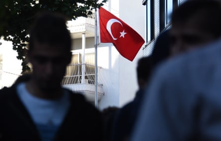 Turkish residents in Japan leave the Turkish embassy after casting their ballots in Tokyo