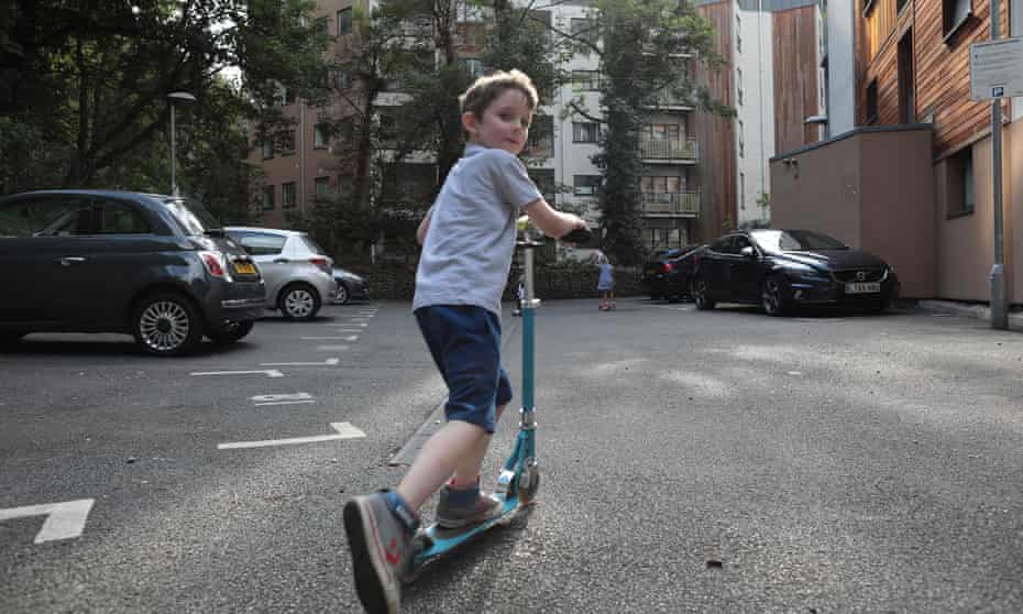 Children without access to a communal play area in Greenwich, south London, play in a car park instead.