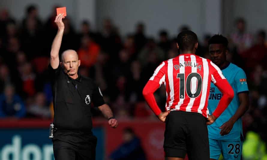 Mike Dean brandishing a red card - a familiar sight.