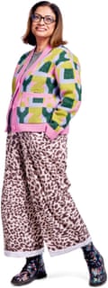 Sajeda wearing a brightly patterned cardigan in pink, green, yellow and grey, loose pink and brown leopard print trousers and patterned boots