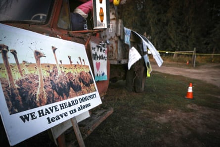 a sign shows a picture of ostriches with text that reads ‘we have herd immunity leave us alone’