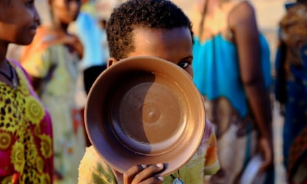 An Ethiopian child queues for food at the Um Rakuba camp, on the Sudan-Ethiopia border in Al-Qadarif state, Sudan