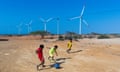 A group of children from the Wayuu ethnic group play soccer in the Jotomana community under some of the turbines of the Guajira 1 Wind Park located on the outskirts of Cabo de la Vela, in the municipality of Uribia in the north of the country and inaugurated on January 22, 2022.