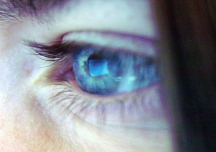 Closeup of an eye with screen reflected in it