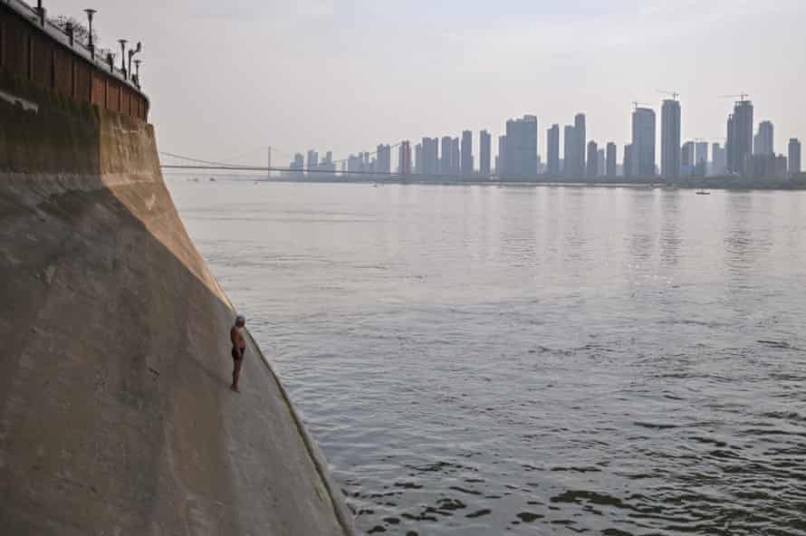 A man prepares to jump into the Yangtze river in Wuhan