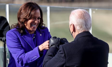 Kamala Harris bumps fists with Joe Biden after she is sworn in as US vice-president.