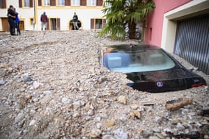 Cressier, Switzerland. A car is buried under rubble after a violent storm caused the Ruhault to flood