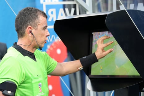 Referee Joel Aguilar reviews the VAR footage, before awarding Sweden a penalty.