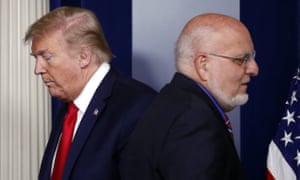 The CDC director, Dr Robert Redfield, with Donald Trump at a coronavirus taskforce briefing on 22 April. Redfield publicly contradicted the president and has not appeared at a briefing since.