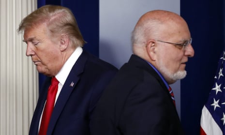The CDC director, Dr Robert Redfield, with Donald Trump at a coronavirus taskforce briefing on 22 April. Redfield publicly contradicted the president and has not appeared at a briefing since.