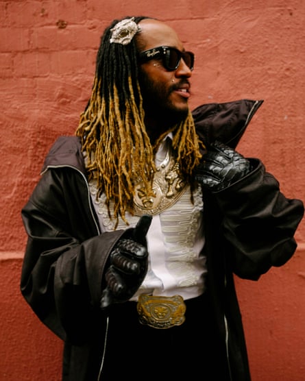 Thundercat standing against a wall in full regalia as described above