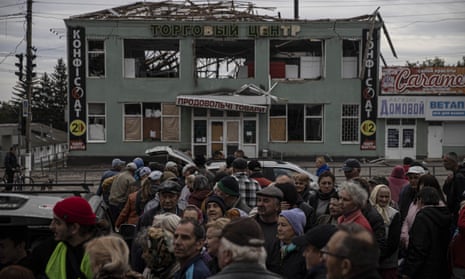 Civilians queue for food after the Ukrainian army liberated the south-eastern town of Balakliia.