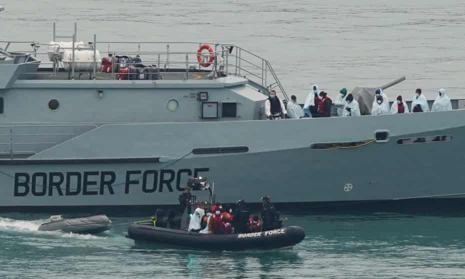 Border Force officers bring a group of people who attempted to cross the Channel in to Dover, Kent