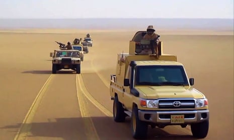Egyptian army pickup trucks and Humvees drive through the desert in north Sinai.