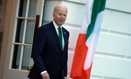 Joe Biden photographed walking out of a door to the White House in a suit and tie