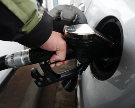 A close-up of someone filling up their car at a petrol station in the UK