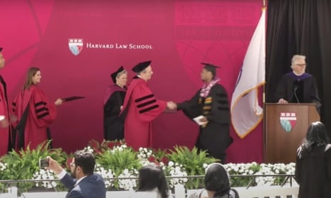 Rehan Staton, in a graduation cap and gown, is conferred his Harvard law degree on Thursday, 25 May 2023.