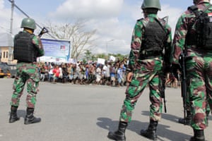 Indonesian soldiers stand guard during a protest in Timika, Papua province, Wednesday, Aug. 21, 2019.