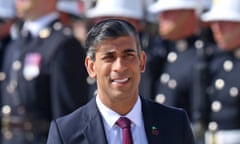 Rishi Sunak in front of a row of military personnel in uniform