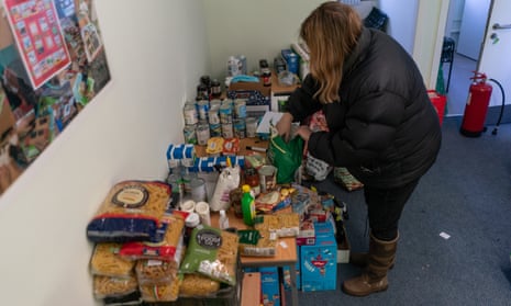 A volunteer with Community for Food unpacking donations in Edinburgh.