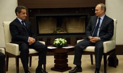 Nicolas Sarkozy seated next to Vladimir Putin