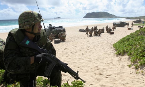 A Japanese soldier sets up a perimeter defence during a simulated beach assault.
