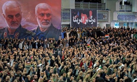 Worshippers chant slogans as a banner shows the Iranian general Qassem Suleimani, left, and Iraqi Shia senior militia commander, Abu Mahdi al-Muhandis, who were killed in Iraq in a US drone attack.