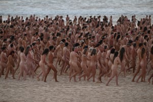 Participants pose nude during sunrise on Sydney’s Bondi Beach for US art photographer Spencer Tunick, to raise awareness for skin cancer, on November 26, 2022.
