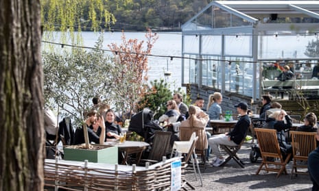 People enjoy the spring weather at an outdoor restaurant in Stockholm, Sweden, 26 April 2020.