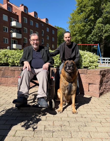 George Mason in a wheelchair next to his son Carl and a dog
