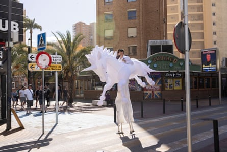 A man dressed in a white horse costume in Benidorm.