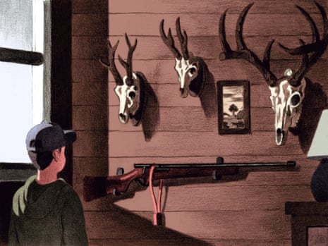 A young person looks at a wall displaying a locked rifle and deer skulls