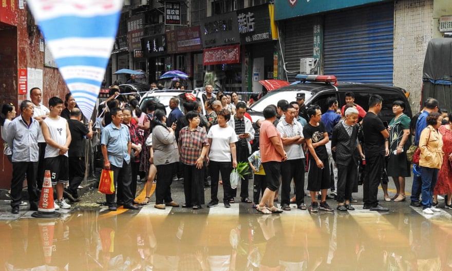 Residents after heavy rain in Dazhou city, Sichuan province.