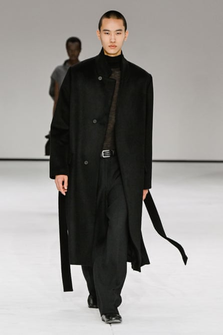 A model in a tailored black outfit
