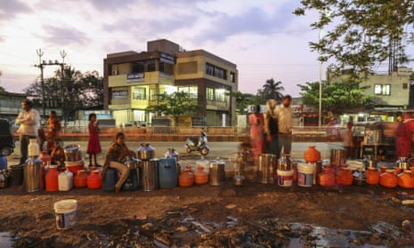 Water commuters wait in line to fill containers at the Vivekananda Chowk water tank in Latur, Maharashtra, India.