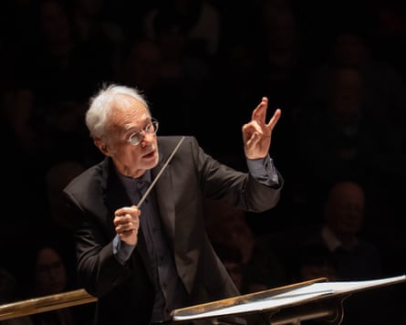 Characteristically charming … John Adams conducting the Hallé at Bridgewater Hall.
