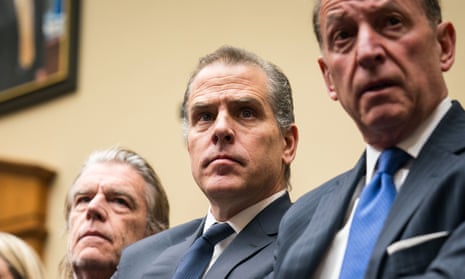Two white men wearing suits, seated next to each other, looking tense.