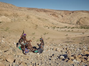 A group of people rest on their journey across Angola’s southwestern border