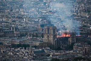 Smoke and flames rise during a fire at the landmark Notre-Dame Cathedral in central Paris