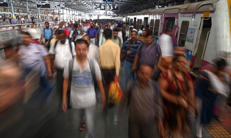 Commuters alight at the Chhatrapati Shivaji Maharaj terminus railway station in Mumbai.
