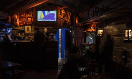 Volodymyr Zelenskiy is shown on a TV screen in a bar in Lviv in March