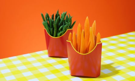 Photograph of two holders for fast-food fries but one with beans in, the other with carrot sticks