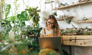 'I couldn't have done it without the group': three small business owners on the things they've learned from each other | Getting back on track 2 Happy young woman using laptop in a small gardening shop