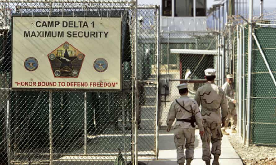 US military guards walk within the Camp Delta prison in June 2006.