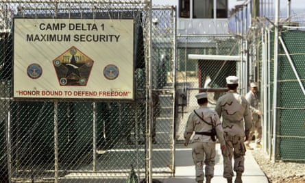 US military guards walk within the Camp Delta prison in June 2006.