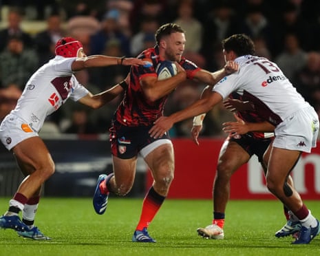 Gloucester's Seb Atkinson is tackled by Bordeaux Bègles' Louis Bielle-Biarrey (left) and Nicolas Depoortère