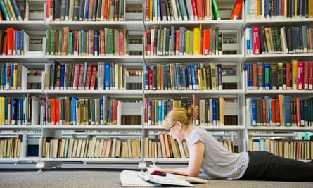 Woman reading textbooks in library