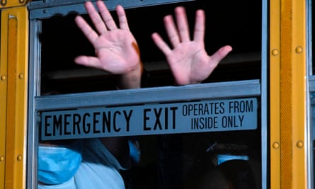 Migrants deported from the United States wave from a bus upon landing at the air force base in Guatemala City earlier this year.