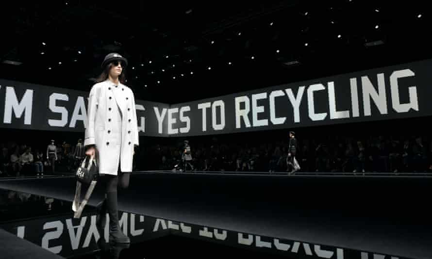 Model walks Tod’s catwalk with a background that reads: ‘I’m saying yes to recycling’.
